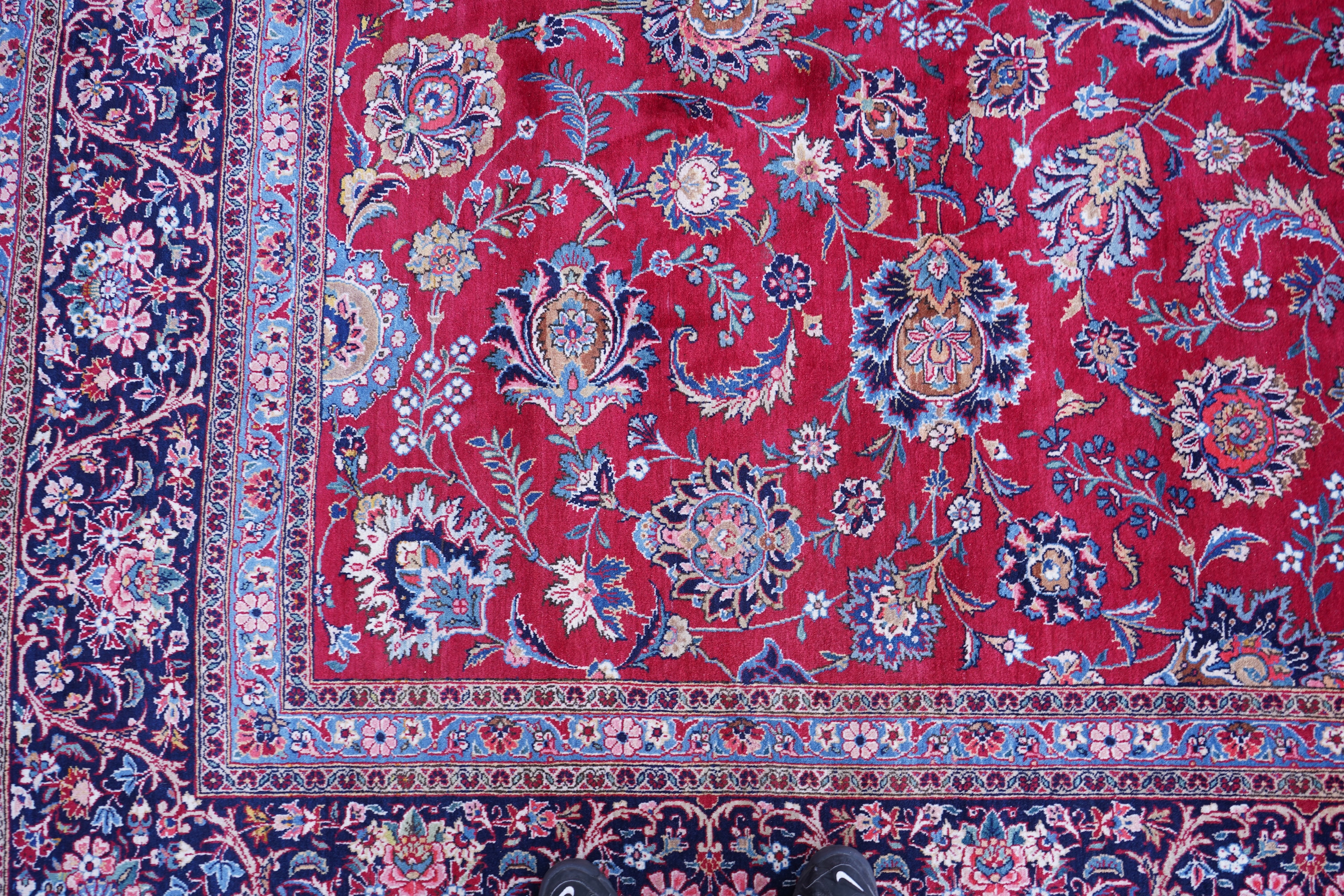 A Kashan burgundy ground carpet